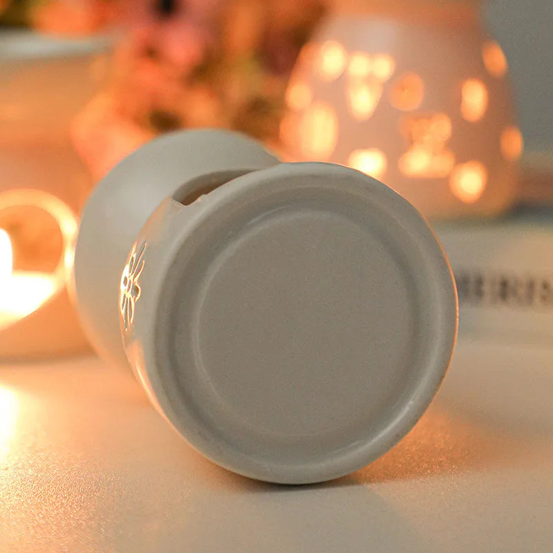 White ceramic oil burner with cut-out pattern