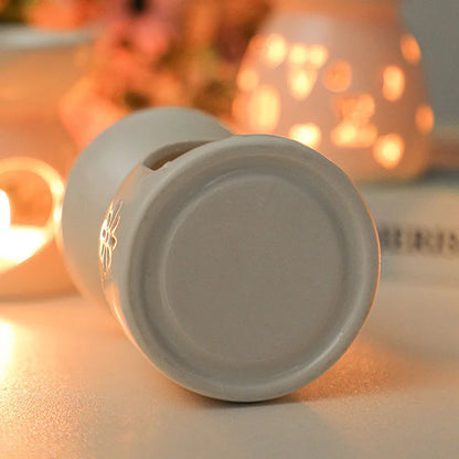 White ceramic oil burner with cut-out pattern