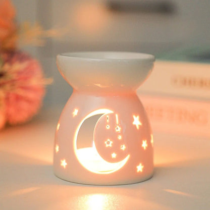 White ceramic oil burner with cut-out pattern