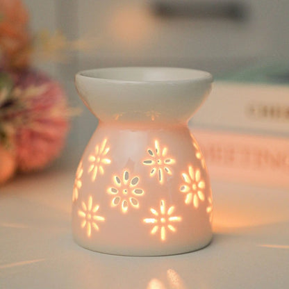 White ceramic oil burner with cut-out pattern