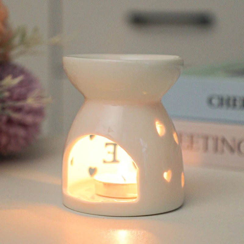 White ceramic oil burner with cut-out pattern