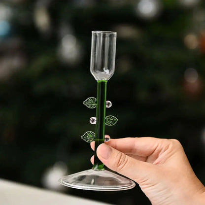 Glass Christmas tree candle holder on a festive table