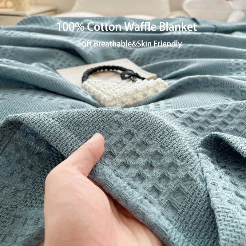 Cotton waffle throw blanket folded on a bed