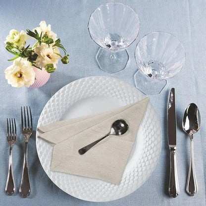 Set of six natural cloth dinner napkins on a table